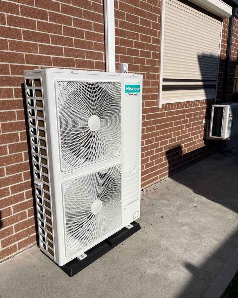 Hisense ducted air conditioning outdoor unit installed against a brick wall