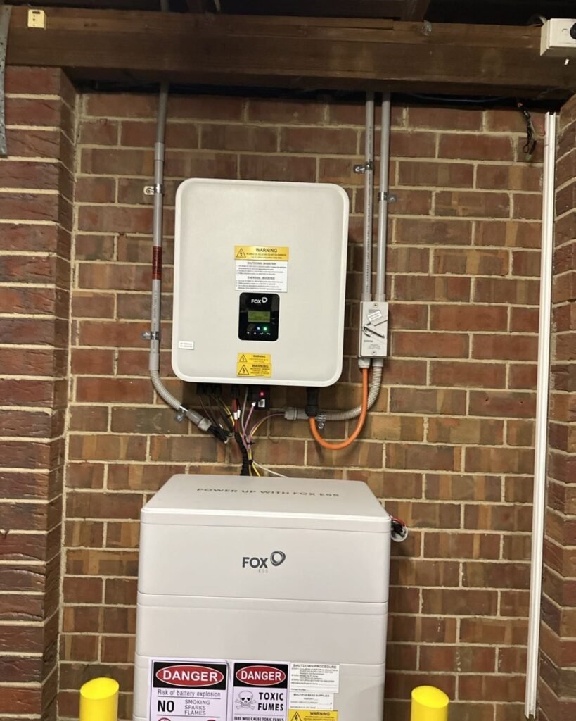 FoxESS home battery and inverter installed on a brick wall