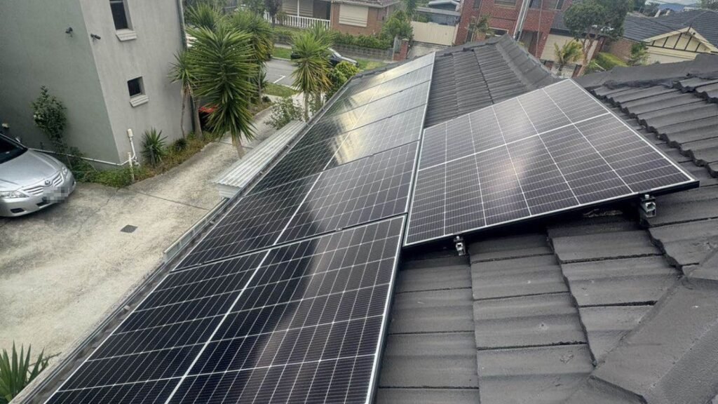 Rooftop solar installation viewed across a suburban roofline